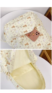 Detail of the spacious main compartment and front pocket on this cartoon dog print backpack