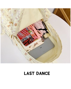 Top view of spacious backpack interior holding an iPad, notebook, and daily essentials