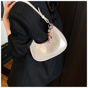 White hobo bag on black blazer featuring cartoon charm and fashion text print details