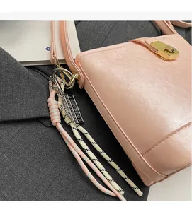 Détail du sac seau rose en PU avec fermoir doré et pendentif boulier original