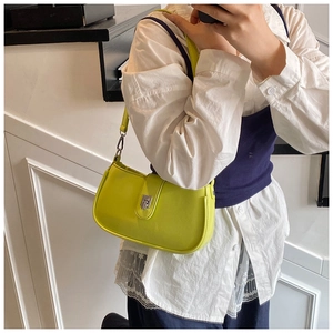 Close-up of bright yellow shoulder bag with silver metallic twist lock and sleek finish