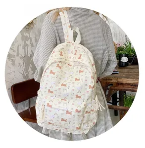 Close-up of a cream canvas backpack featuring cute dachshund and cartoon prints