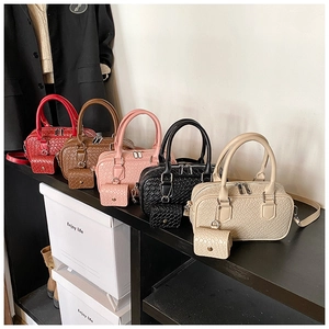 Detail of woven texture Boston bags in five colors with matching coin purse charms