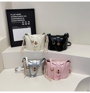 Fashionable crossbody bags in white, black, silver, and pink with gold twist locks