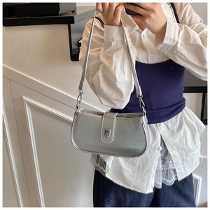 Close-up of metallic silver underarm bag featuring sleek texture and metal buckle detail