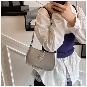 Silver metallic leather shoulder bag with sleek metal clasp shown in a mirror selfie