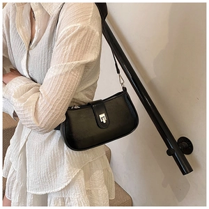 Black leather hobo bag with vintage silver buckle styled with a white textured dress