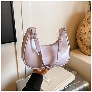 Detail of lavender crescent bag showing glossy texture and silver buckle accents