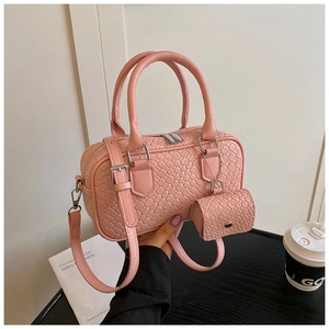 Pink woven bowling handbag with matching mini pouch and adjustable crossbody strap