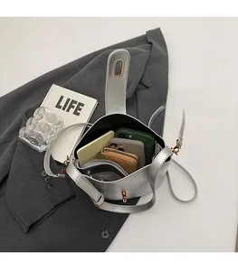 Interior view of silver leather bucket bag showing capacity for two phones and wallets