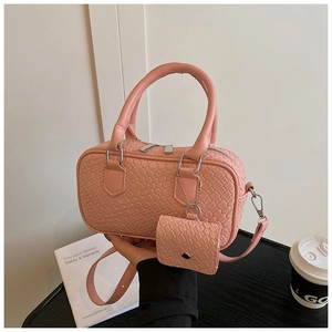 Detailed shot of pink textured bowling bag with mini coin purse and silver metal hardware