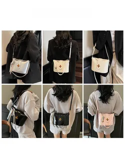 Detail view of the elegant crossbody bucket bag in multiple colors with silk scarf accent