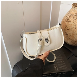 Detail of cream PU leather shoulder bag with silver buckle and sleek modern design