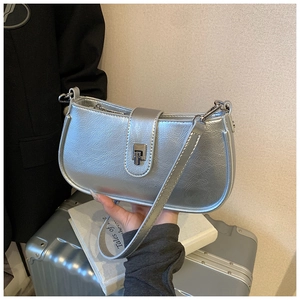 Detail of silver metallic bucket bag with pleated leather texture and metal lock closure