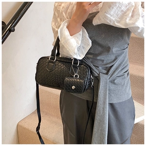 Detail of black woven leather bowling bag with silver hardware and small coin purse attachment
