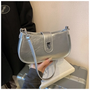 Close-up of metallic silver hobo bag with moon shape and stylish metal buckle detail