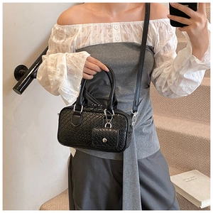 Detail view of black woven texture shoulder bag featuring a small detachable coin purse