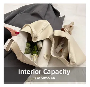 Top view of cream tote bag interior showing large capacity and matching inner pouch