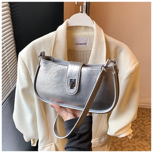 Close-up of silver metallic handbag with crinkle texture and polished metal buckle