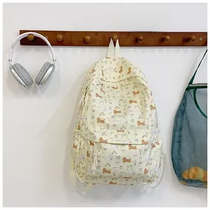 Close-up of cream canvas backpack with cute dachshund and poodle cartoon print