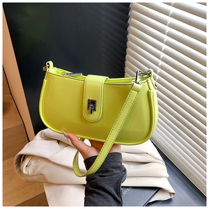 Close-up of neon green baguette bag with silver twist lock and smooth synthetic leather