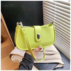 Close-up of lime green half-moon bag with silver metal twist lock and lychee texture