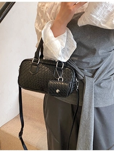 Elegant black textured bowling handbag with mini pendant pouch and adjustable shoulder strap