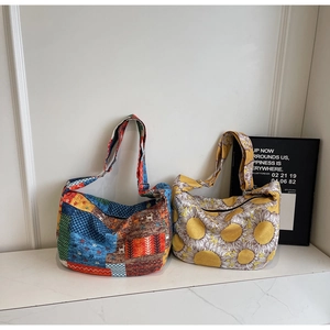 Detail of canvas shoulder bags featuring patchwork ethnic patterns and sunflower prints
