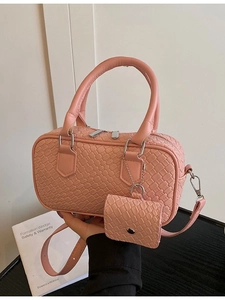Pink woven texture bowling handbag with mini charm and adjustable shoulder strap