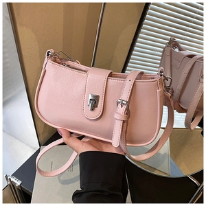 Detail of light pink pebble leather bucket bag with silver lock and mirror reflection
