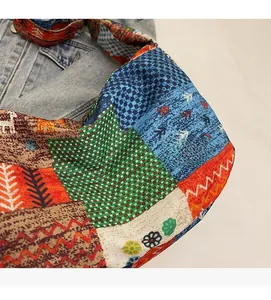 Detailed view of colorful patchwork canvas bag with vibrant ethnic patterns and textures