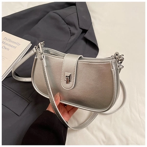 Close-up of silver hobo bag featuring metallic pleated texture and metal buckle lock
