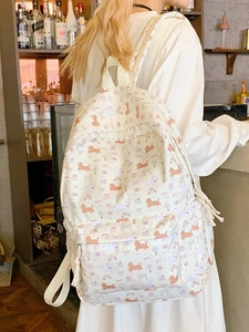 Stylish white backpack with cartoon dog prints and adjustable straps for school or travel