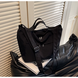 Macro shot of durable black nylon fabric and functional zipper pockets of the tote bag
