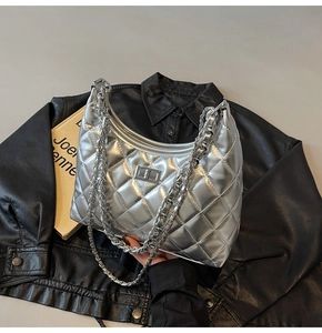 Macro view of silver quilted hobo bag with metallic finish and metal turn-lock closure