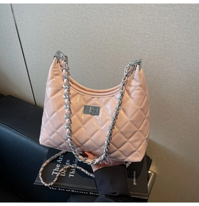 Detail of pink quilted leather bag with silver metal chain strap and twist lock