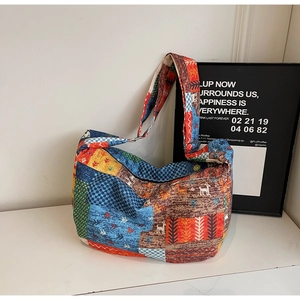 Close-up of ethnic style patchwork canvas bag with colorful patterns and wide strap