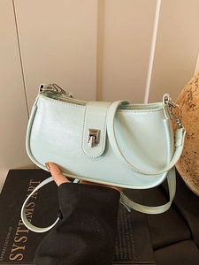 Pale mint green high-shine shoulder bag with silver turn-lock and slim strap