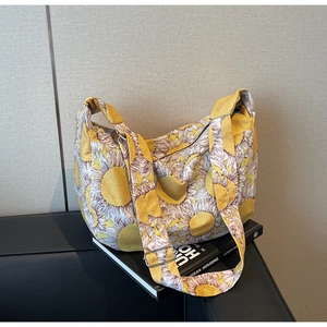 Detail of adjustable strap and vibrant sunflower pattern on large canvas tote bag