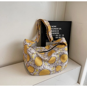 Detailed close-up of vibrant sunflower print on canvas tote bag with black zipper