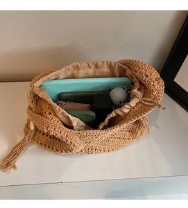 Top view of handmade crochet tote with fringe detail showing spacious drawstring interior