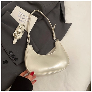 Close-up of pearl white hobo bag showing texture, long strap and fashion lettering