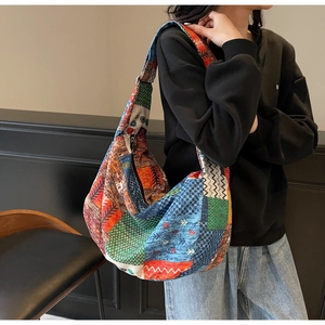 Detail of vintage patchwork canvas hobo bag with ethnic geometric and floral patterns