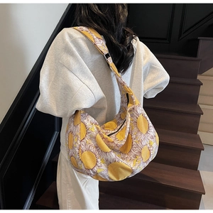 Close-up of hobo bag featuring sunflower print and adjustable wide shoulder strap
