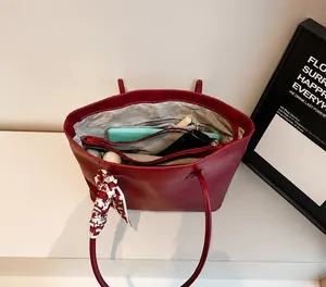 Interior detail of red leather tote bag showing large capacity for tablet and umbrella
