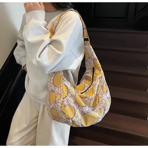 Large canvas shoulder bag featuring a vibrant yellow sunflower print and zipper closure