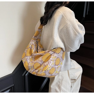 Detail shot of large canvas shoulder bag with yellow sunflower print and zipper closure