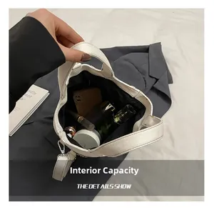 Top-down view of spacious interior of off-white canvas tote bag with daily essentials