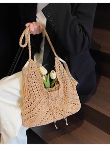 Handmade crochet hollow-out beach tote bag with tassels and drawstring closure
