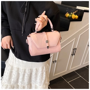 Sac à main rose avec rabat en cuir lisse et texture tissée doté d'une boucle métallique